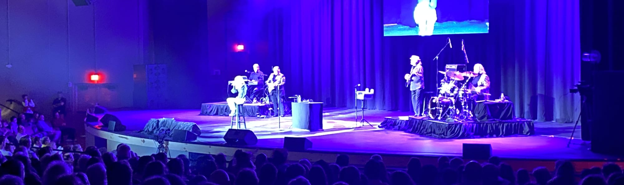 signer on stage in chair washed out by the lights San Francisco